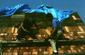 Guys working on the roof of the Kent Barn, Calais