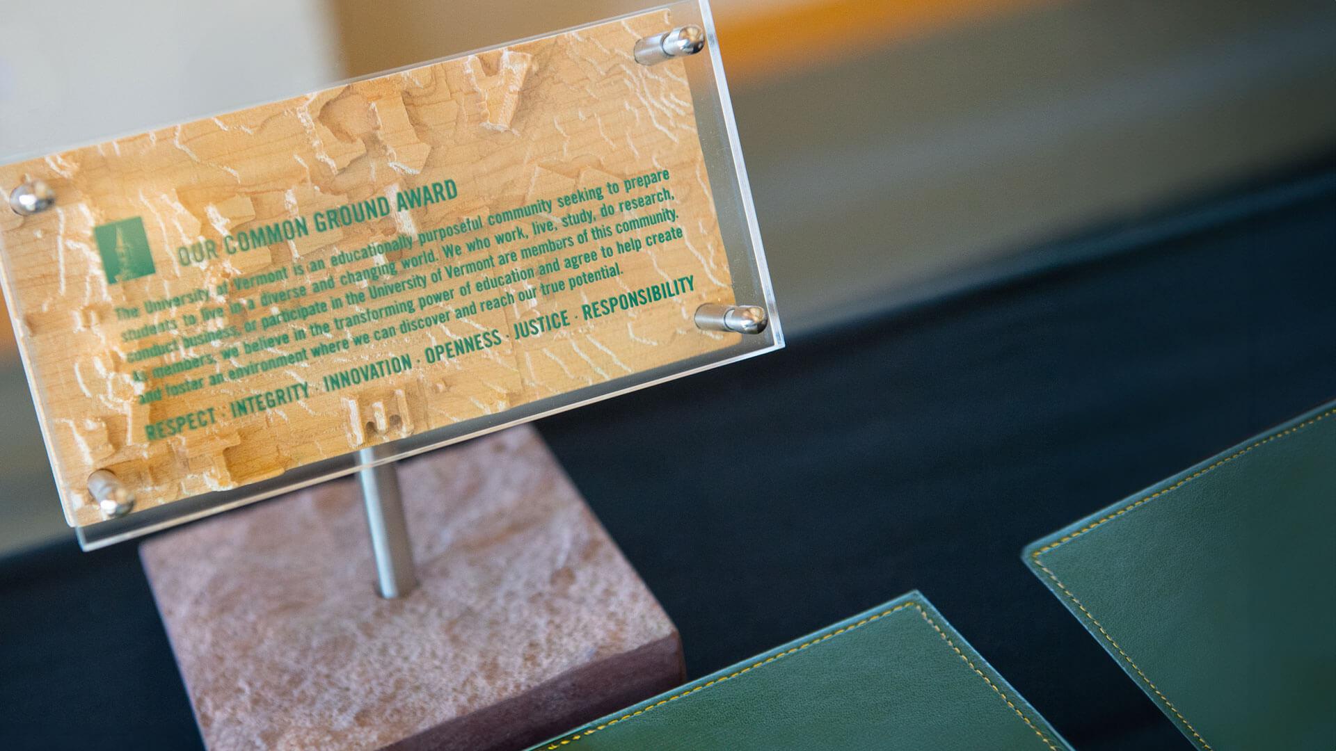 close up of a wooden our common ground award on a table
