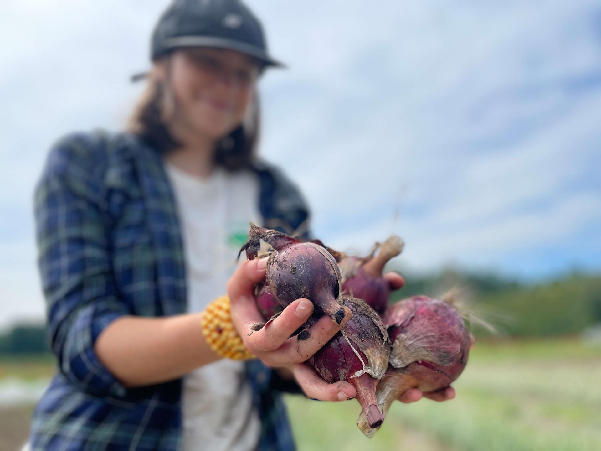 A student holds recently harvested beets.