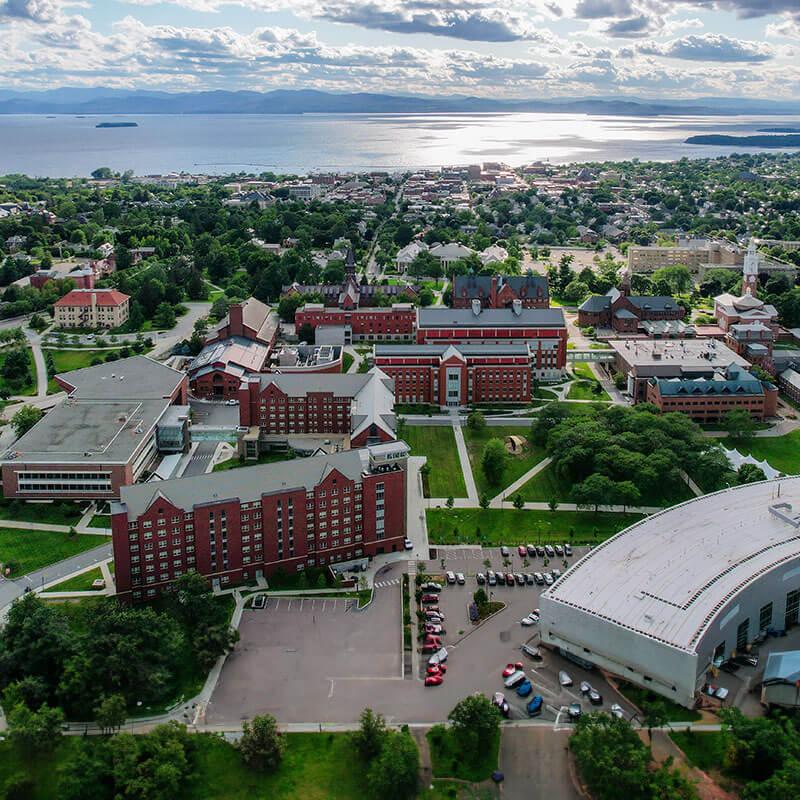 drone shot of campus with the lake in the background