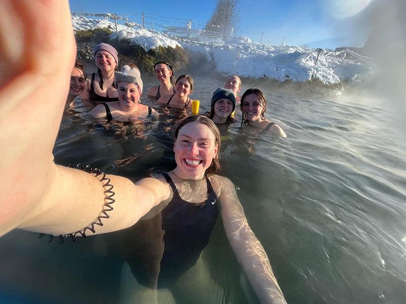 a group of people taking a selfie in a hotspring