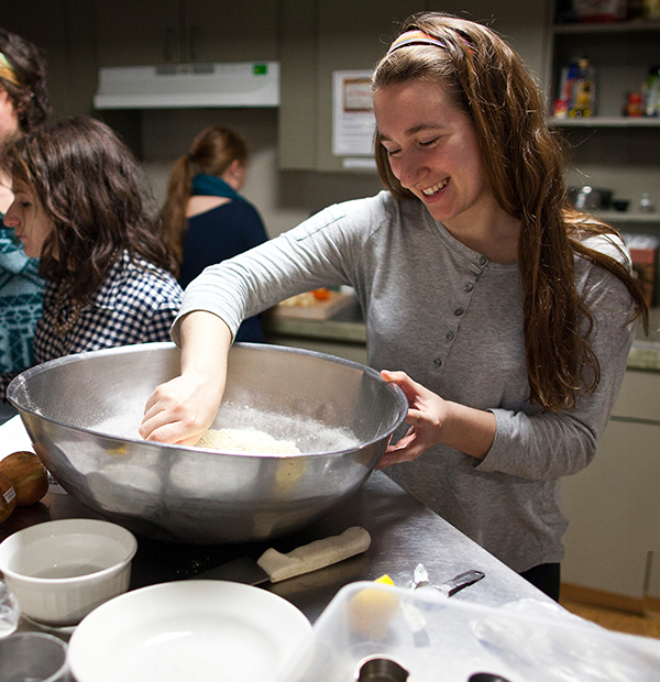 Student cooking in a teaching kitchen