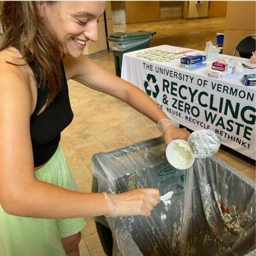 Person dumping food waste into trash bin