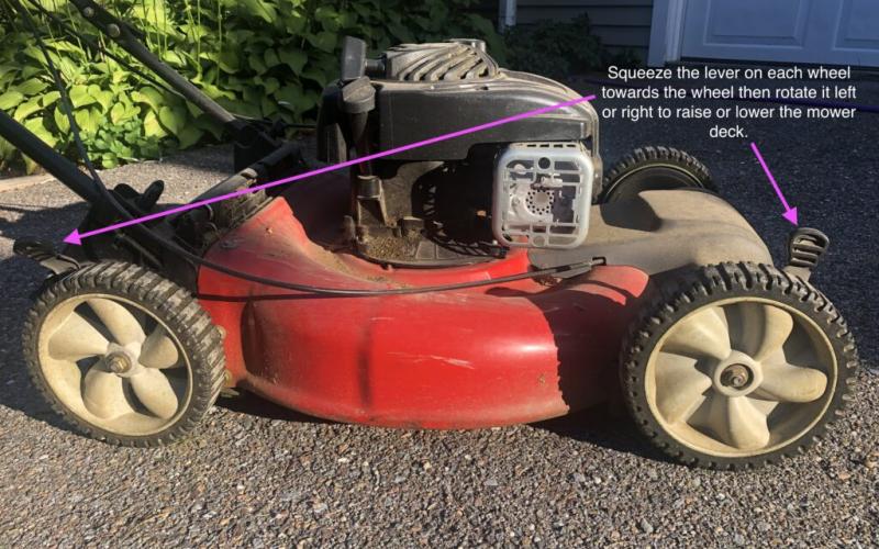 Traditional lawn mower with arrows showing how to adjust cutting height