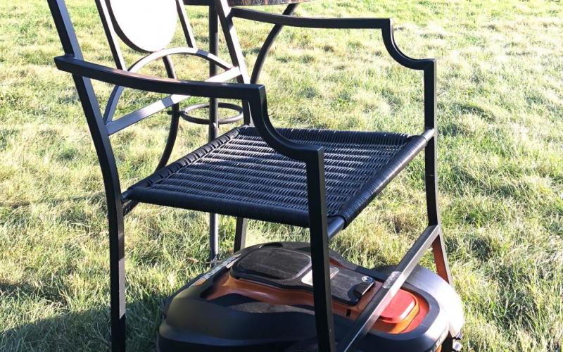 Mo, the robotic lawnmower, gets stuck under a metal chair