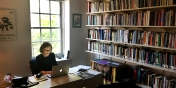Helen Scott working in her book lined office on UVM campus