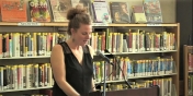 Eve Alexandra speaking to a group in a library setting