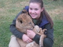 student holding lion cub