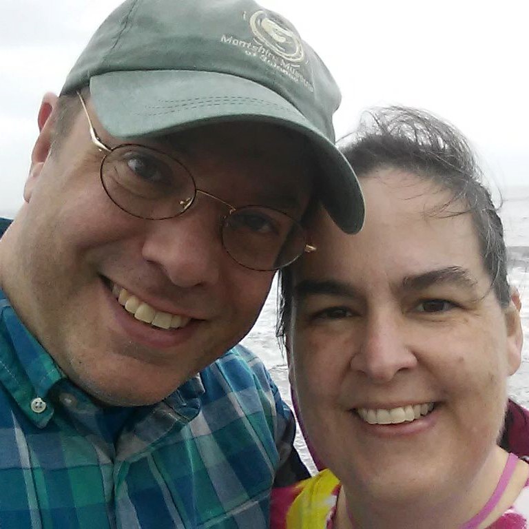 Geoff and spouse selfie with ocean in background.