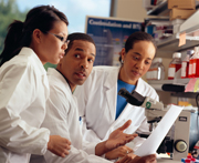 Three researchers analyzing data.