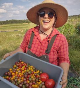 Laura Fredrickson-Gosewisch with crate of vegetables