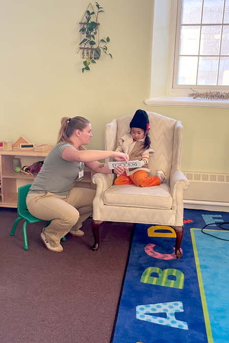 Larner medical student Caroline Duksta ’26, helps screen a child for vision abnormalities at the Family Connections Program Space.  