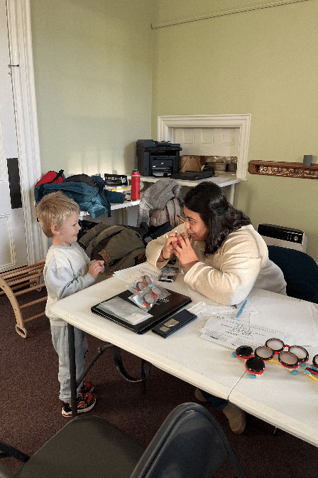 Sujata Singh, M.D., Larner assistant professor of ophthalmology and UVM Medical Center opthamologist, meets with a child attending the vision screening follow-up at the Family Connections event.