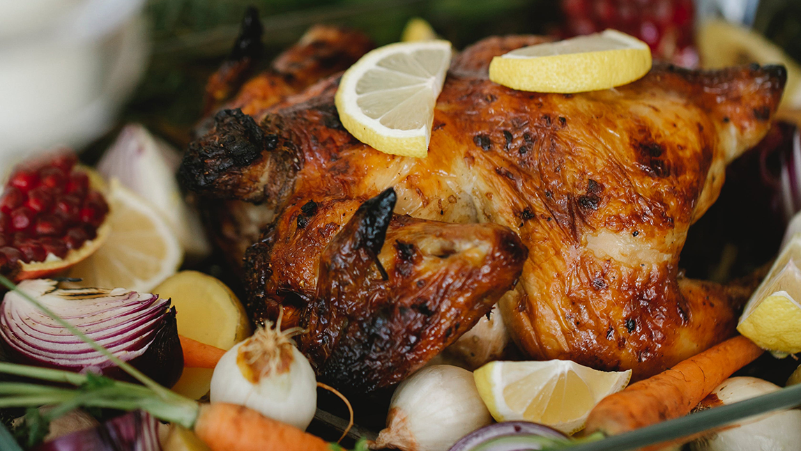 golden brown poultry with citrus, cranberry, onion and carrots