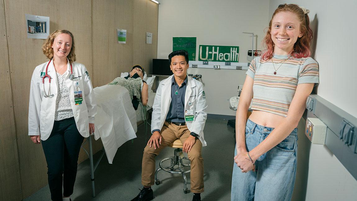 Larner College of Medicine students Lindsay Aldrich ’25 and Richard Vuong ’25 join XXXX XXXXX inside a mock-up of the rural healthcare delivery vehicle. 