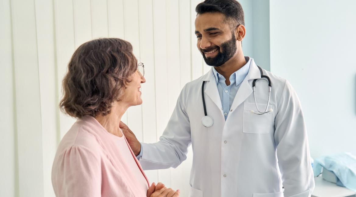 a doctor in a white coat smiling at a patient