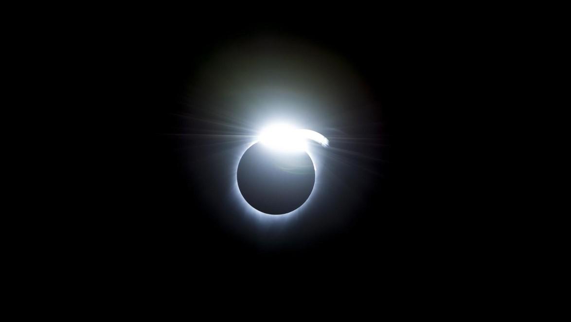 An image of the "diamond ring effect," which is a dark circle with one bright spot on the side, during a solar eclipse. Credit: NASA