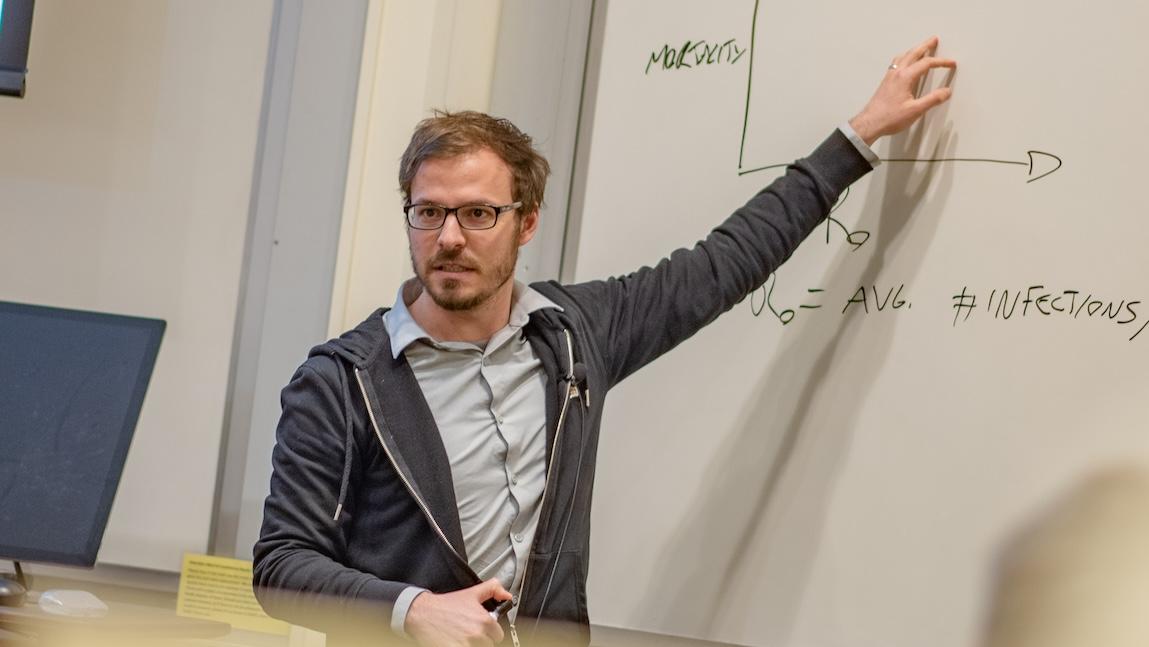 Laurent Hebert-Dufresne lecturing at a whiteboard