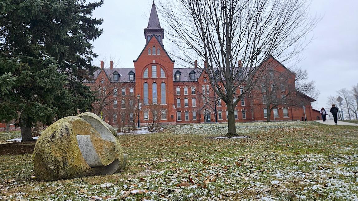 View of the UVM Green and "Unlocked" sculpture with Old Mill in background