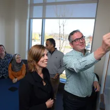 Professors writing on whiteboard