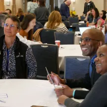 Smiling folks at a round table