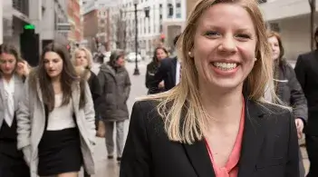 students walk toward the camera smiling