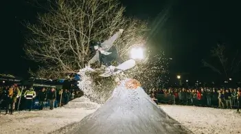 Student snowboarding off a jump