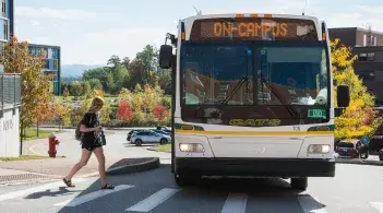 A university CAT Bus at a stop on campus.