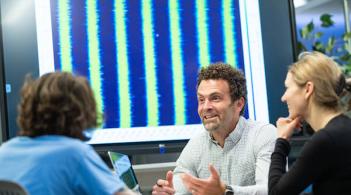 Chris Danforth talking with colleagues