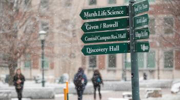 Campus signage showing the direction of a number of UVM buildings.