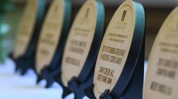 Row of awards plaques on a table