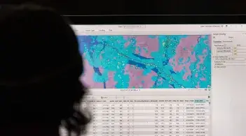 A person staring at a computer monitor