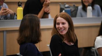 Student conversing with a Student Services team member during orientation