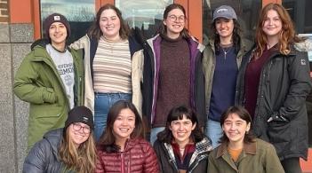 The Femmes in Forestry club posing for a photo outside, five women in the back and four women in the front.