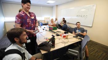 Students playing a video game at a meeting for the Neuro student interest group