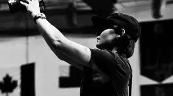 Photographer standing over a crowd taking photos