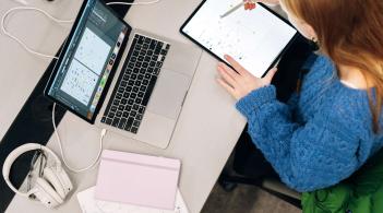 Student using computer and tablet