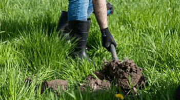 Shovel scooping dirt