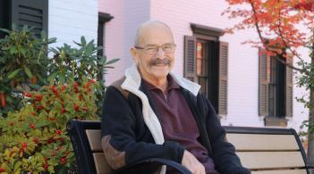 Richard Ryan, UVM Cancer Center patient, sits on a bench outside Hope Lodge. 