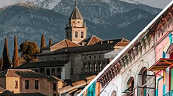 Scenic city view with church steeple and towering mountains in the back