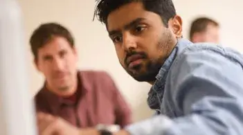 Student looking intently at ultrasound equipment