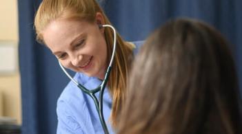 student listens to patients breathing