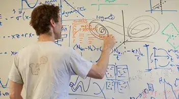 Professor writing on a white board