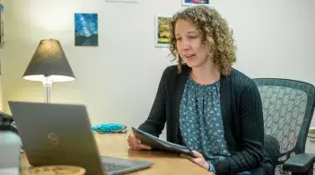 Dietitian Amy Sercel has a telehealth appointment on her laptop