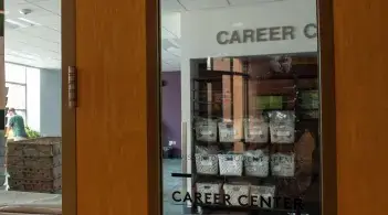 Photo of door that says Career Center and has center hours listed