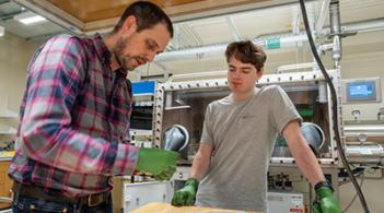 Physics faculty research Dr. Alex Kozen working with an undergraduate student in his lab