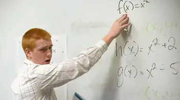 Student teacher explains an equation at a whiteboard
