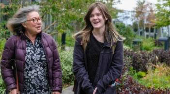 Older person and student walking 