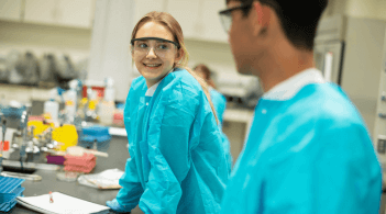 Woman in lab with welcoming smile