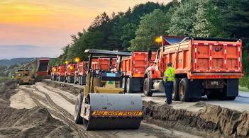 Trucks lined up to deliver aggregate for a VTrans construction project